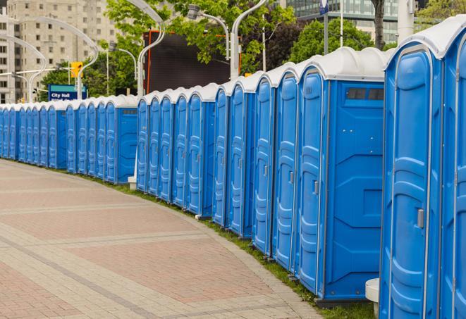 hygienic portable restrooms lined up at a beach party, ensuring guests have access to the necessary facilities while enjoying the sun and sand in Brisbane CA